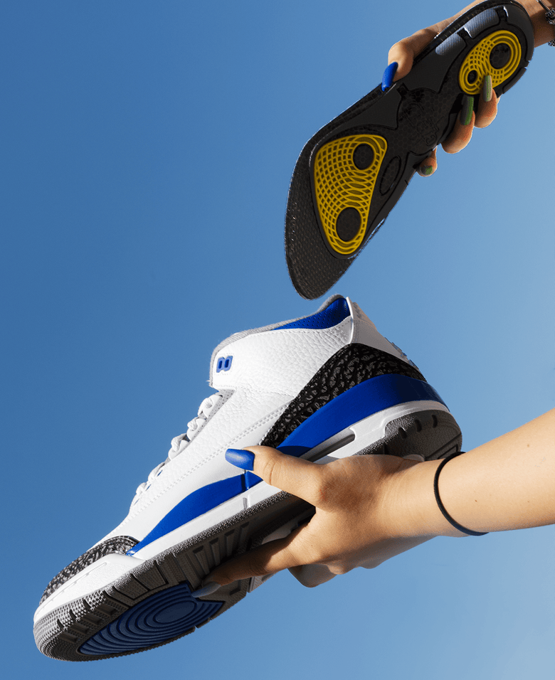 Crep Protect woman holding a Nike sneaker and a gel insole, demonstrating footwear comfort.